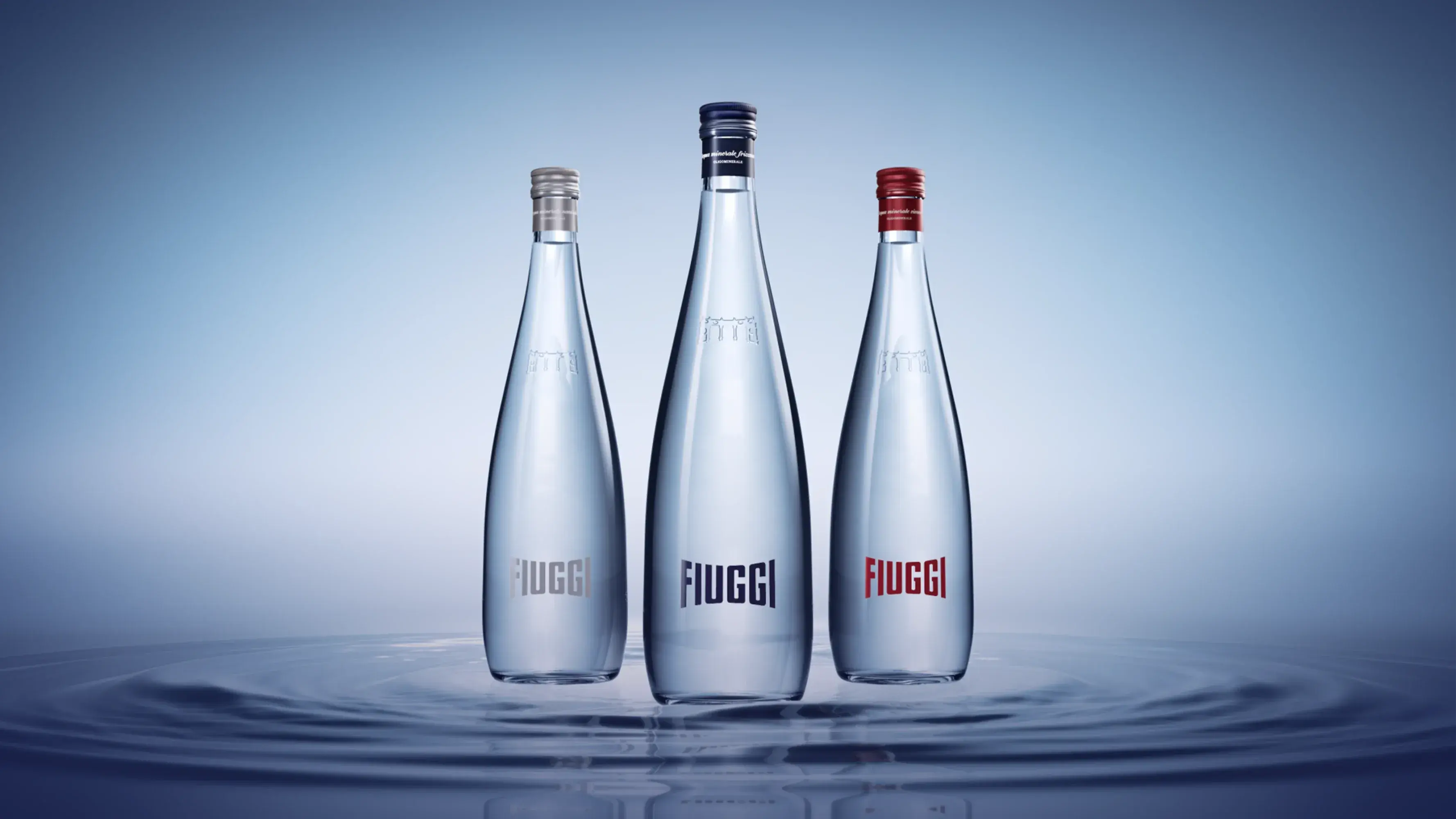 Acqua Fiuggi Luxury: still, sparkling and vivace glass bottles on a light blue background